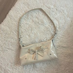White glossy shoulder bag with ribbon bow